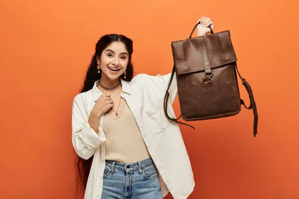 A young indian woman with a brown backpack strikes a graceful pose. — Stock Photo