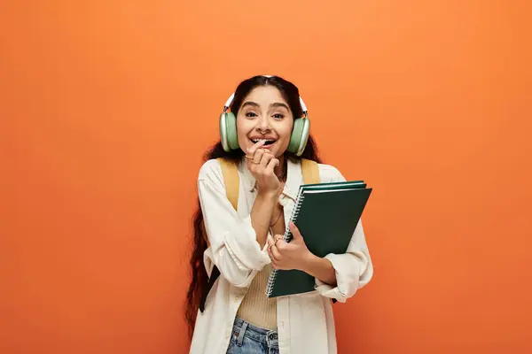 Young indian woman with headphones and notebook. — Stock Photo