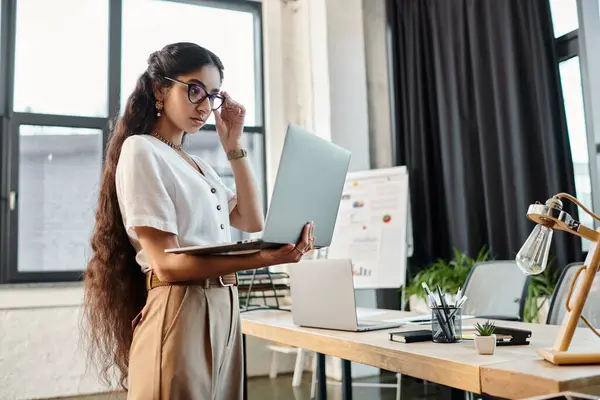 Young indian woman engaged with laptop on desk. — Stock Photo