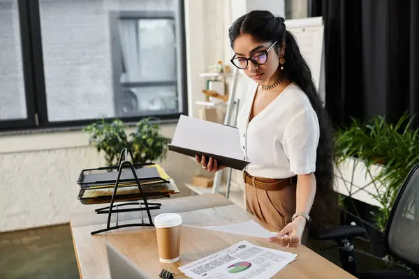 Jeune femme indienne avec des lunettes de travail au bureau avec des papiers. — Photo de stock