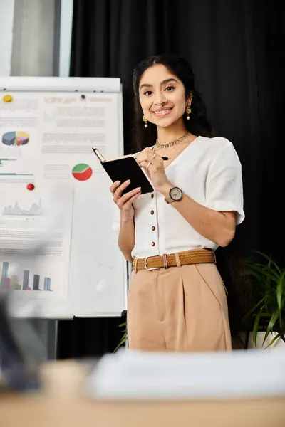 A young indian woman poses in front of a white board. — Stock Photo
