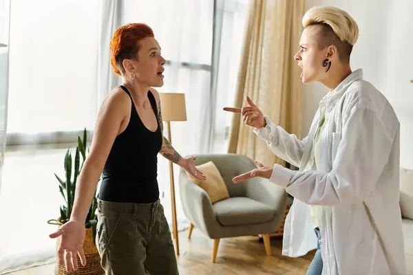 Two women in intense argument in a cozy living room setting, expressing emotions and frustrations. — Stock Photo