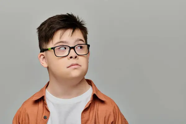 A boy with Down syndrome wearing glasses. — Stock Photo