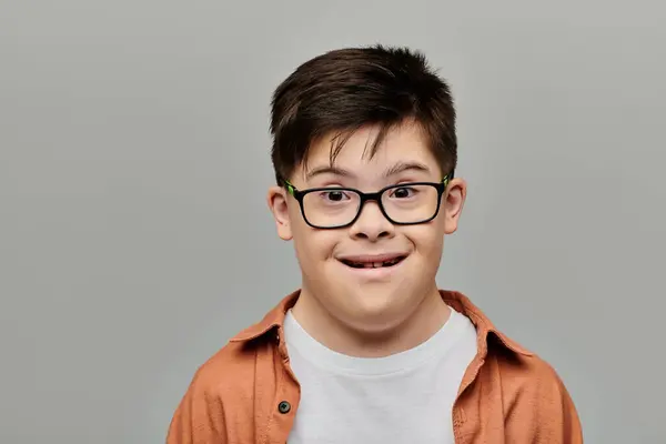 A charming little boy with Down syndrome playfully making a funny face. — Stock Photo