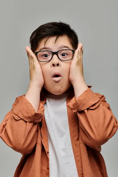 Little boy with Down syndrome with glasses looking at camera. — Stock Photo