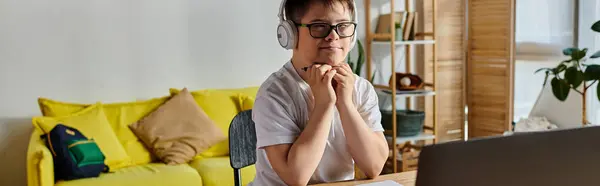 Adorable boy with Down syndrome engaged with laptop. — Stock Photo