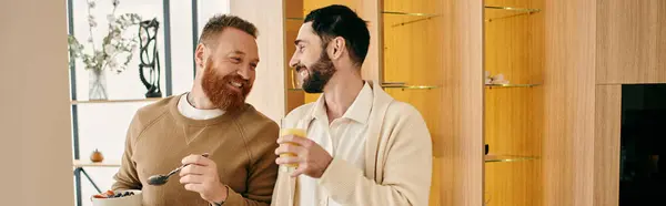 Two bearded men engage in a lively discussion in a modern kitchen setting. — Stock Photo