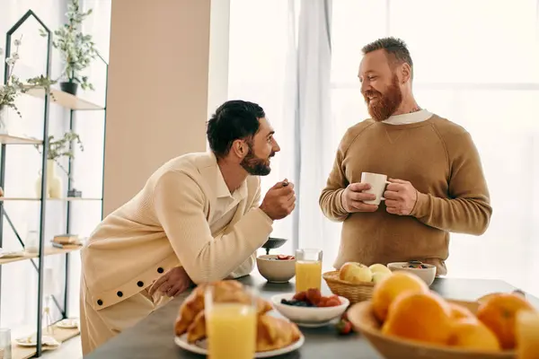 Two men engaged in conversation while seated at a table in a modern setting, sharing quality time together. — Stock Photo