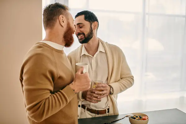 Two men engrossed in conversation in a cozy kitchen, sharing love and laughter in a modern apartment setting. — Stock Photo