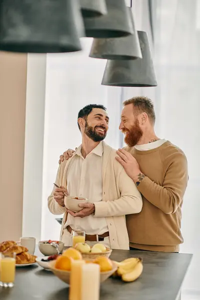 A happy gay couple embraces in a warm hug in a modern kitchen, celebrating their love and bond. — Stock Photo