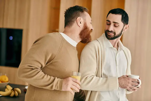 Two men engaged in conversation in a cozy kitchen setting, sharing a moment of connection and companionship. — Stock Photo