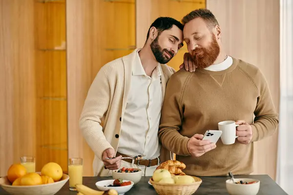 Two men with beards happily eating breakfast in a modern kitchen. — Stock Photo