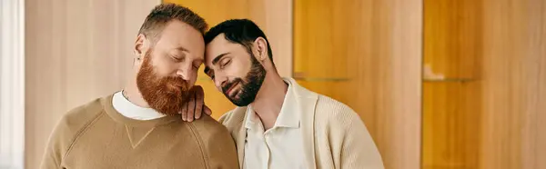 Two happy gay men hug each other warmly in a modern apartment, displaying their love and connection. — Stock Photo