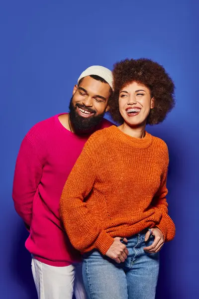 A young African American man and woman, dressed in vibrant casual attire, stand side by side in a display of friendship. — Stock Photo