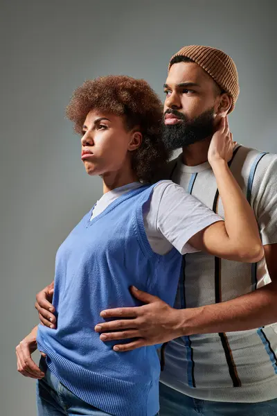 An African American man with a beard stands next to a woman in stylish clothes, showcasing a strong bond of friendship. — Stock Photo