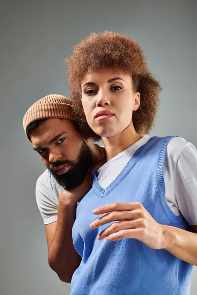 African American friends in stylish clothes showcase their friendship while posing on a grey background. — Stock Photo