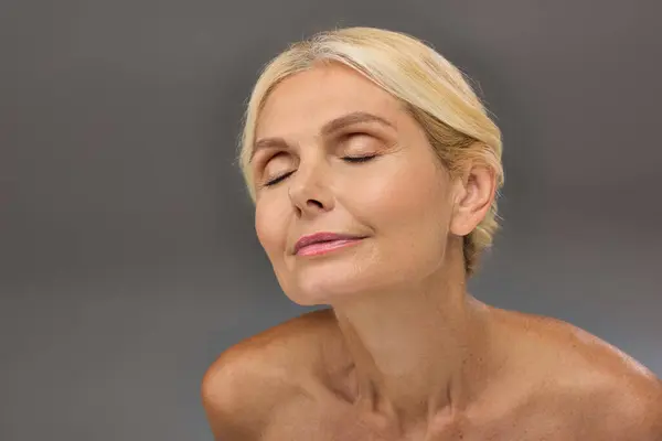 Mature woman peacefully posing with eyes gently closed. — Stock Photo