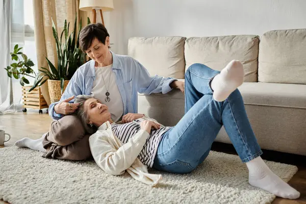 Two women peacefully lounging on the floor at home. — Stock Photo