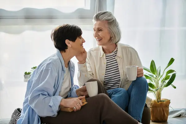 Two women sitting on floor, engaged in deep conversation. — Stock Photo