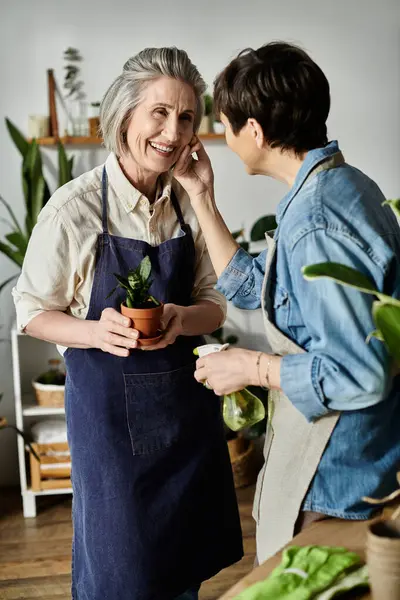 Two women engaged in conversation while in a kitchen. — Stock Photo
