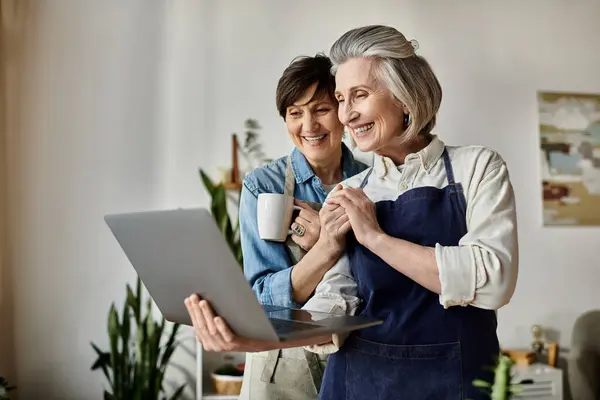 Two women engaged with laptop together. — Stock Photo