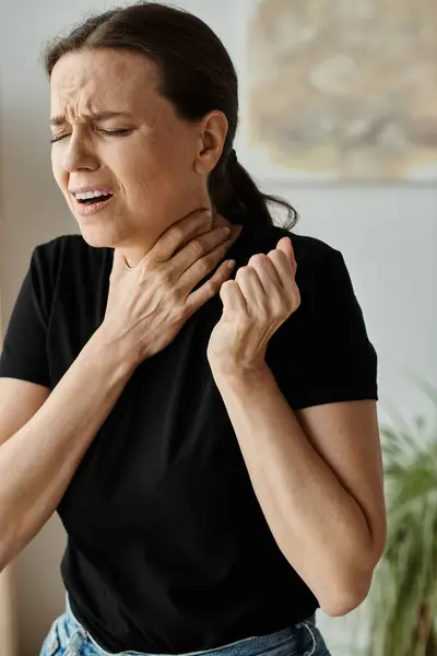 Depressed middle-aged woman at home experiencing neck pain. — Foto stock