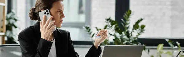 A woman communicates on the phone at her cluttered desk. — Stock Photo