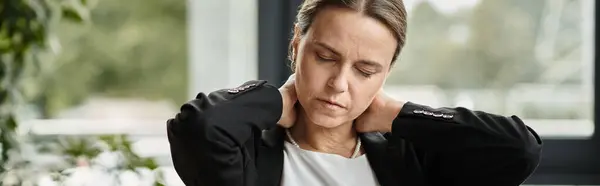 Woman holding neck in pain at office, depression. — Fotografia de Stock