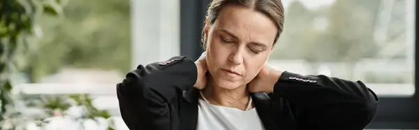 Woman holding neck in pain at office, depression. — Stock Photo
