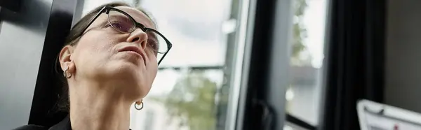 Woman in glasses gazes away, depression. — Stock Photo