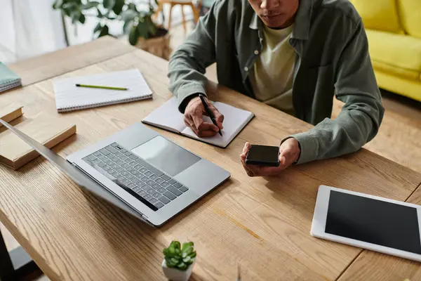 Young African American man studying online with laptop, tablet, and phone. — Stockfoto