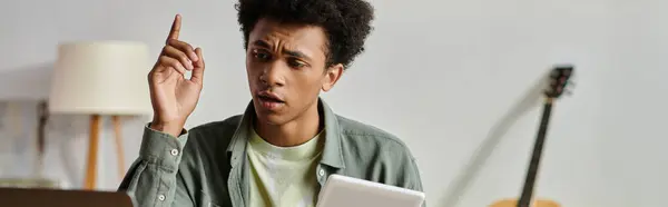 Young man engrossed in online study. - foto de stock