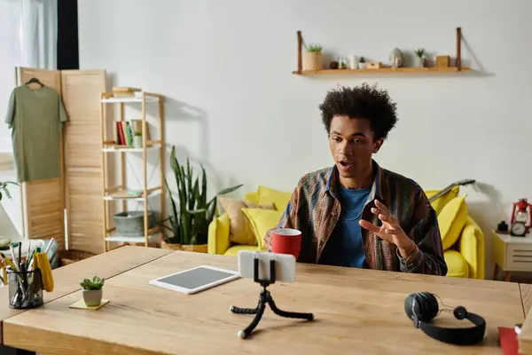 Young African American male blogger engaging with tablet during video call. — Stock Photo