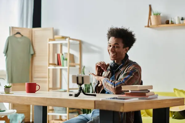 Young man with phone at desk. — Stock Photo