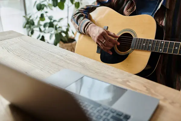 A guitarist strums passionately in front of a phone while connecting digitally. — Stock Photo