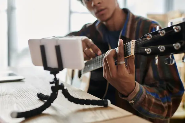 Man plays guitar in front of phone while recording a vlog. — Stock Photo