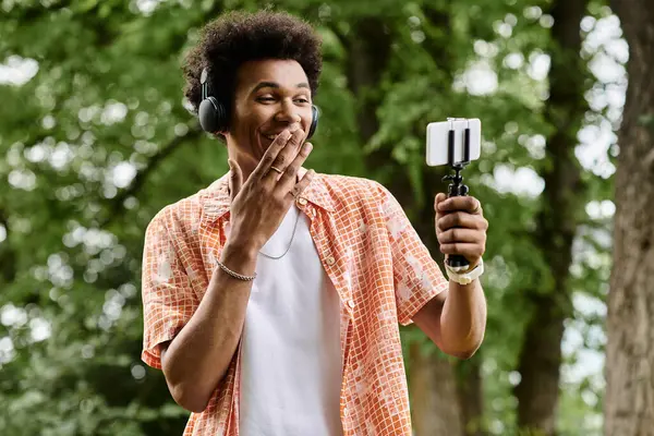 Young man of African descent taking a selfie in a park. — Stock Photo