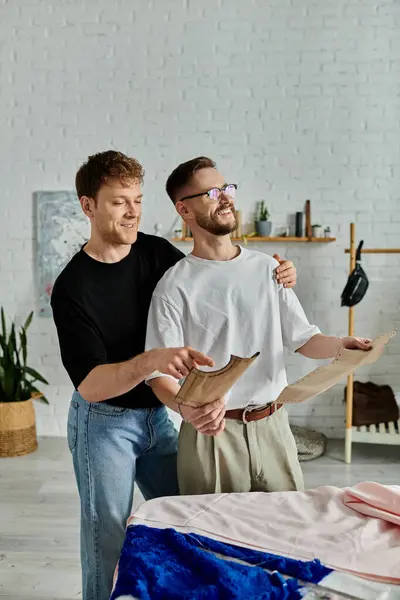 Two men in designer workshop, creating trendy attire together. — Stock Photo