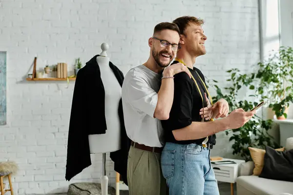 Two men work side by side in a designer workshop, creating trendy attire. — Stock Photo
