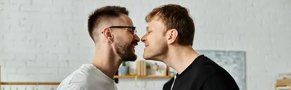 Two men, a gay couple, stand side by side in a designer workshop, collaborating on trendy attire. — Stock Photo