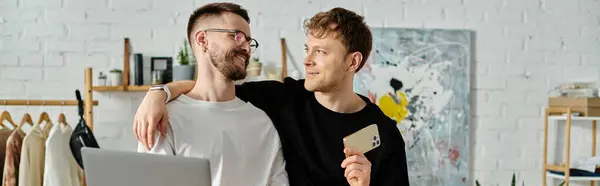 Two men, a gay couple, stand side by side in a designer workshop, focused on creating trendy attire. — Stock Photo