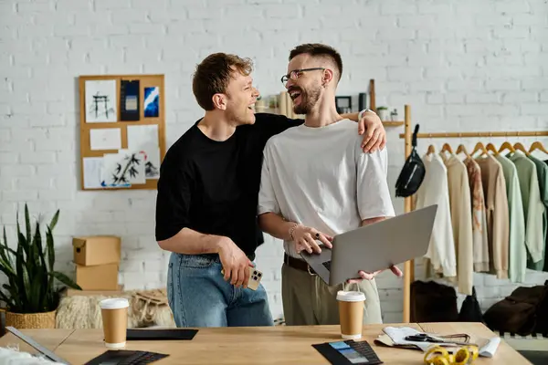 A gay couple collaboratively designs trendy attire in their designer workshop. — Stock Photo