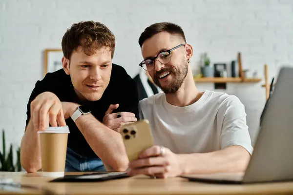 Two men, designers, passionately collaborate on a laptop for their trendy attire. — Stock Photo