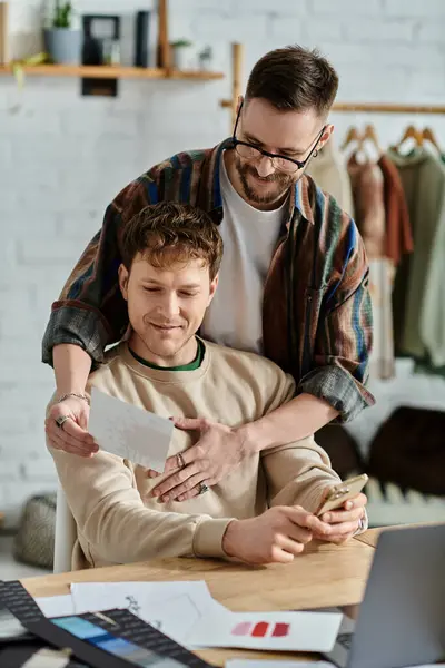 Two men in designer atelier, working together on laptop — Stock Photo