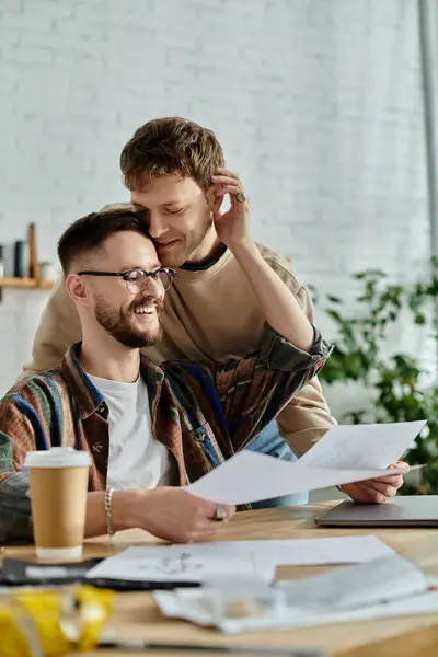 Two men in a designer workshop, discussing fashion papers. — Stock Photo