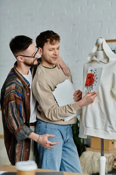 Two men, part of a gay couple, carefully study a fashionable shirt displayed on a mannequin. — Stock Photo