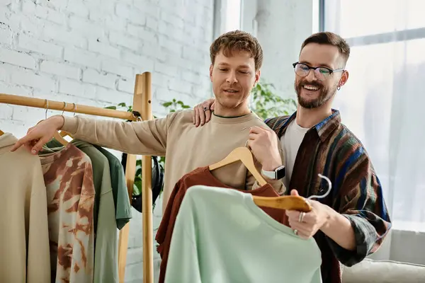 Two stylish men, partners in work and love, stand side by side in their designer workshop. — Stock Photo