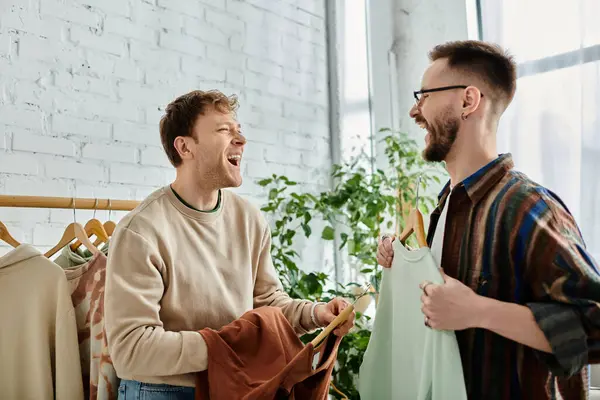 Two stylish men share a moment of unity while collaborating on original designs in a designer workshop. — Stock Photo