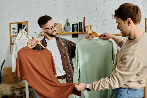 Two men standing together in a designer workshop, passionately creating trendy attire. — Stock Photo