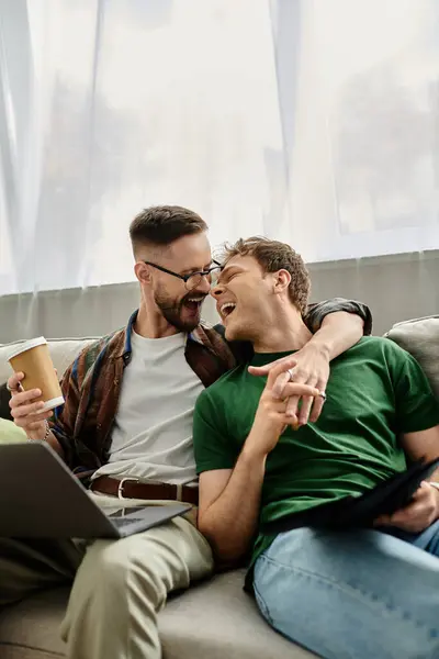 Two men, part of a designer duo, sit atop a luxurious couch, brainstorming innovative and trendy designs together. — Stock Photo